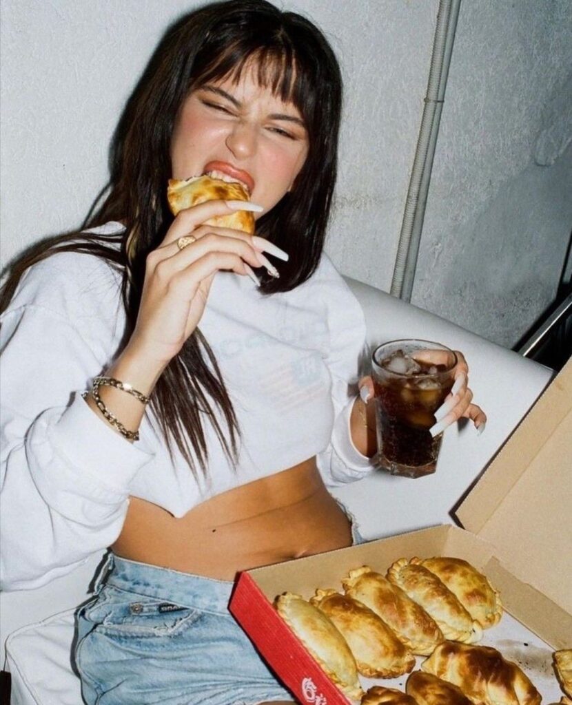 person eating empanada